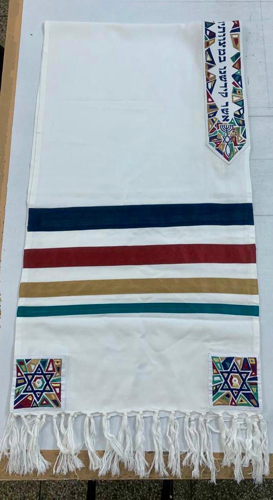 The Cyrus tallit with custom Hebrew scripture folded over.