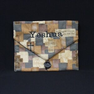 The tallit embroidered brown bag that says Yeshua.